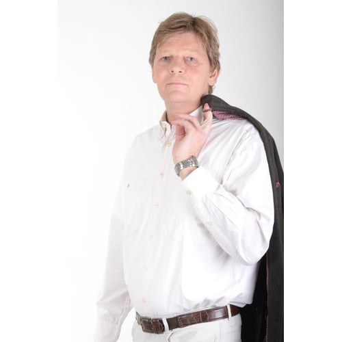 Dutch Actor Peter Rene as a Chique Person Visiting with Blazer, Standing Upright Looking Aside into the Lens Holding Blazer with One Finger over his Shoulder