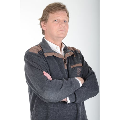 Dutch Actor Peter Rene as a Chique Person in Casual Clothing, Standing Upright Arms Crossed Looking Aside