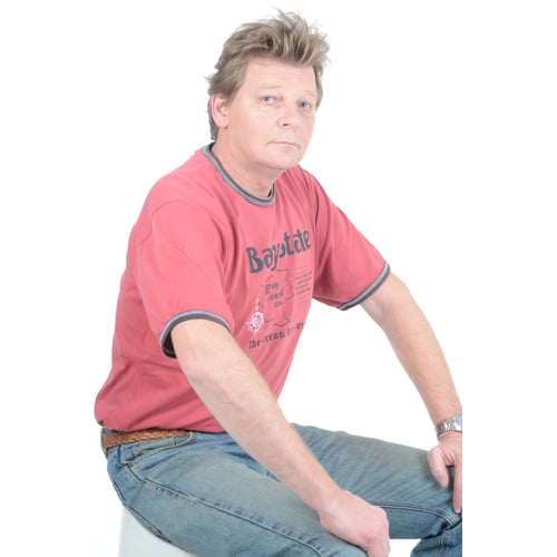 Dutch Actor Peter Rene as a Construction Worker in Workwear, Standing Upright Arms Crossed Picture taken from a Slightly Oblique Perspective