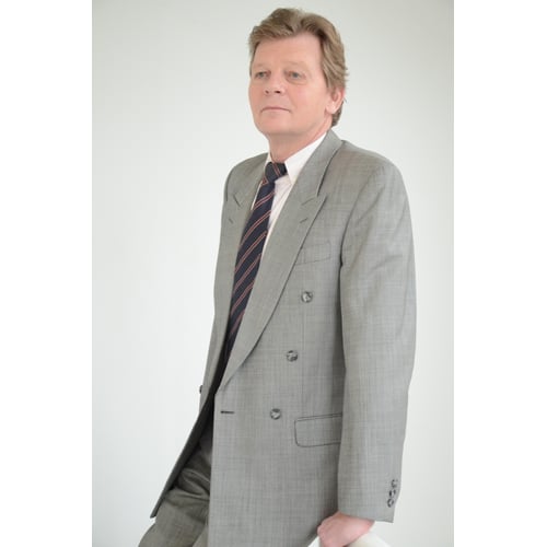 Dutch Actor Peter Rene as a CEO in Chique Suit, leaning against railing